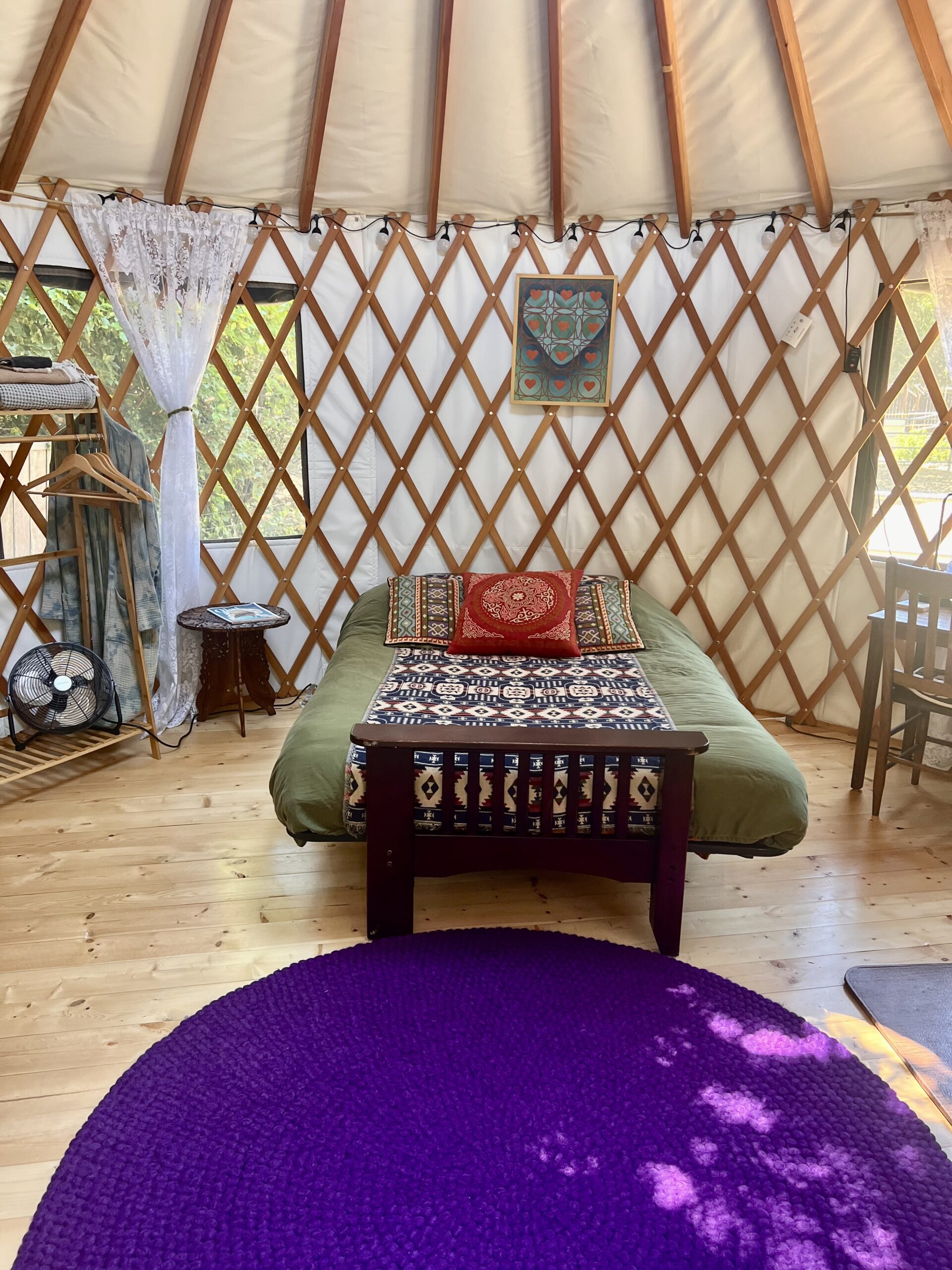 16’ round green Pacific Yurt with tiny fireplace