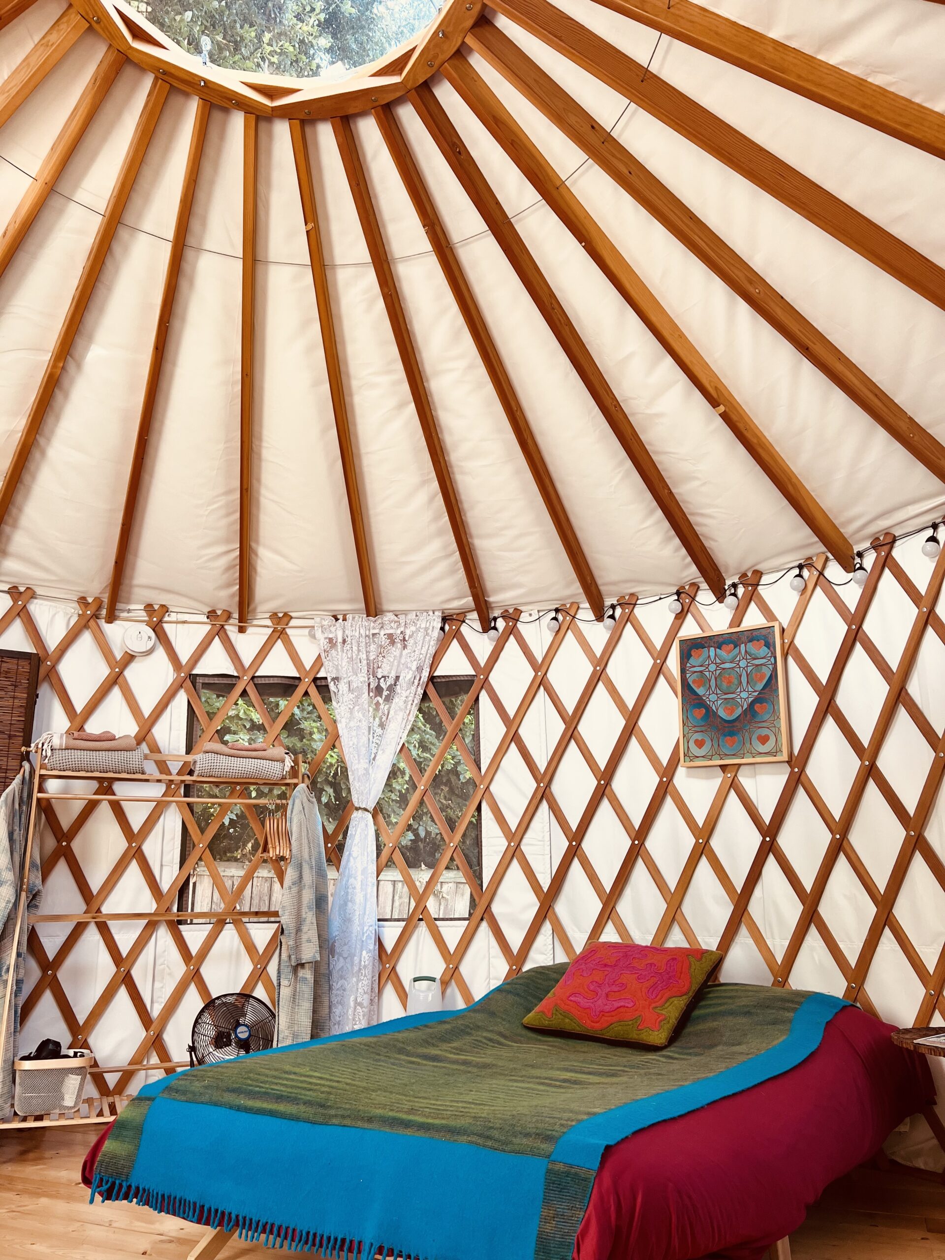 16’ round green Pacific Yurt with tiny fireplace